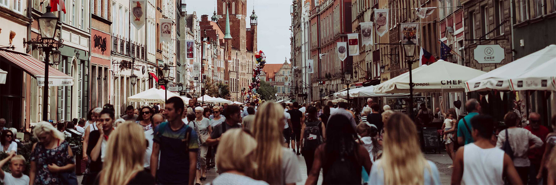 A street filled with people in Gdańsk, Poland.