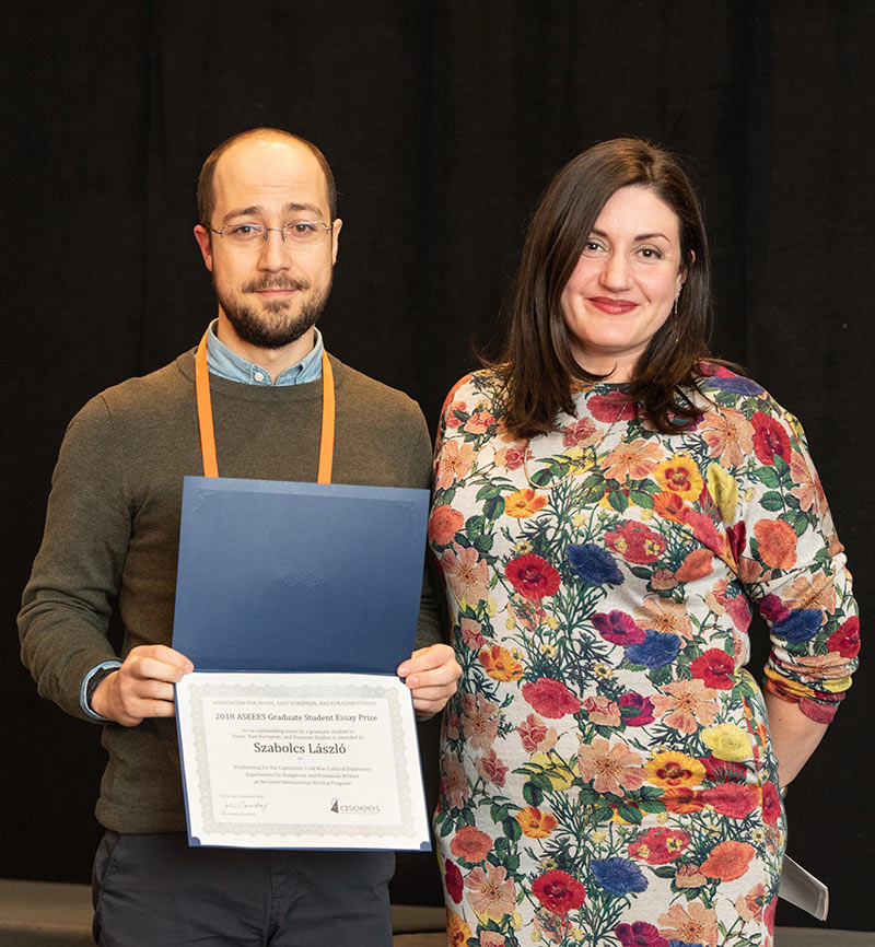 Two people displaying certificate