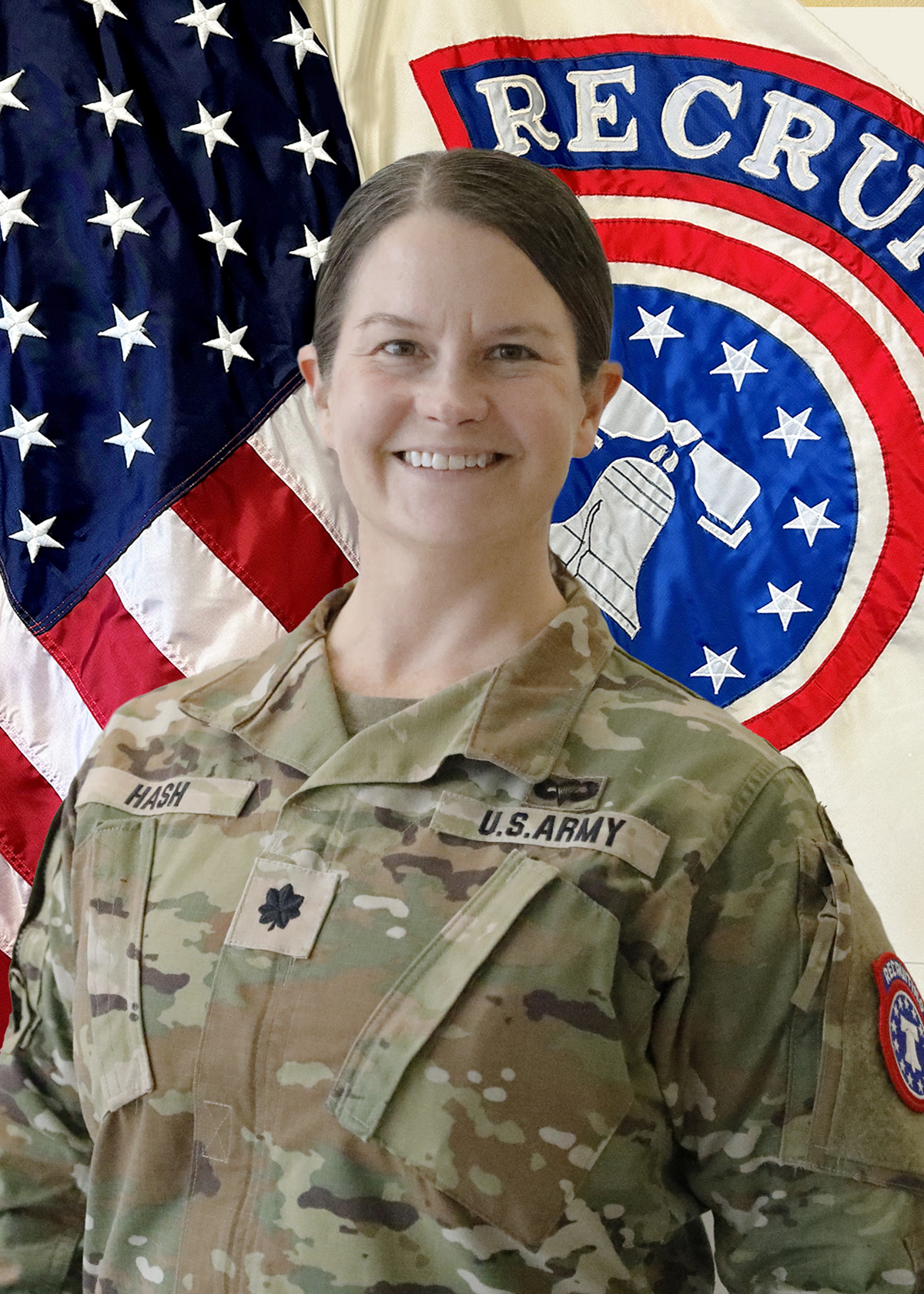 A soldier in army fatigues in front of an American flag background