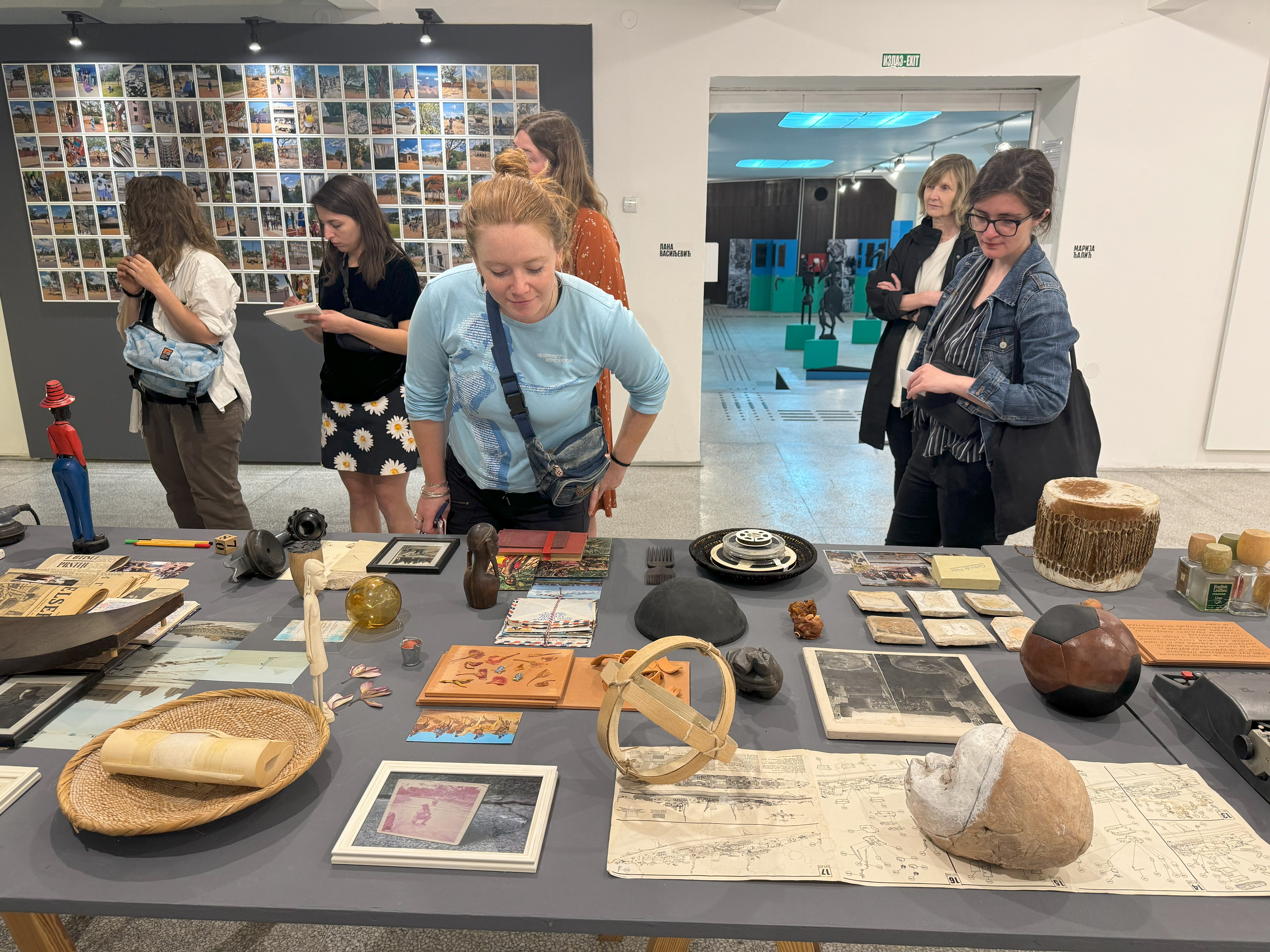 Students examining museum artifacts on a table